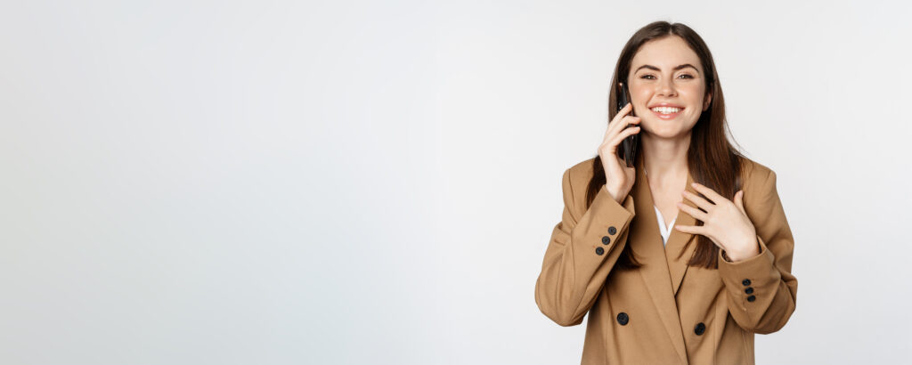 businesswoman having mobile call conversation smartphone talking with client standing white background brown suit